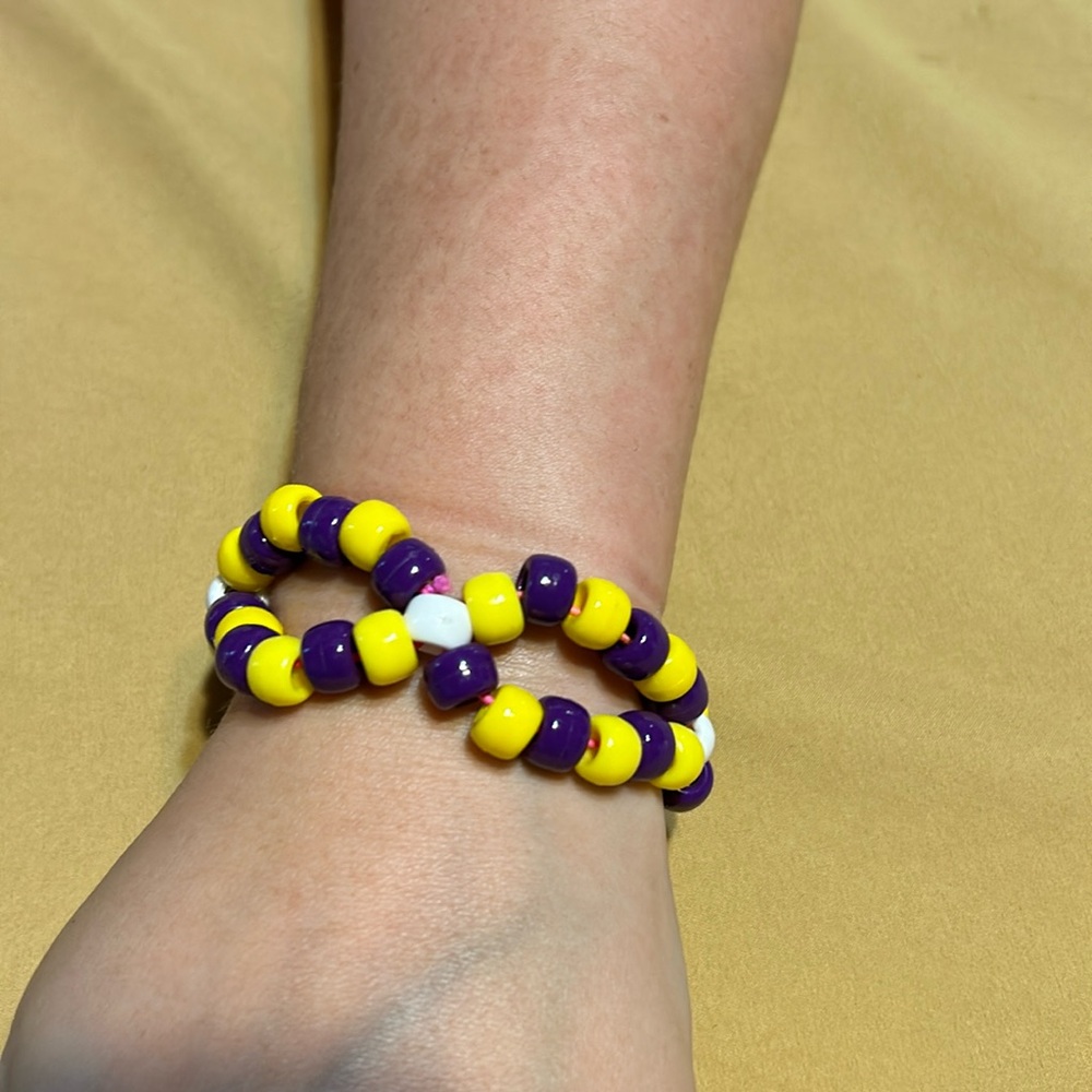 Beaded bracelet and charm. Yellow and purple.